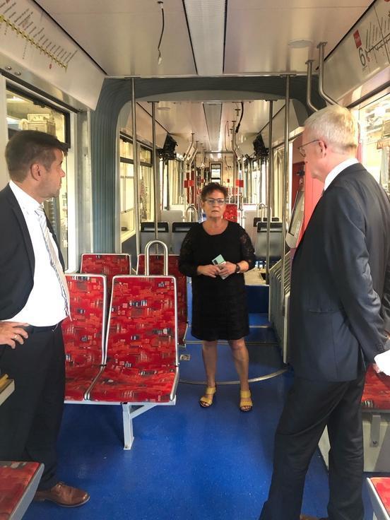 Zwei Politiker stehen in einer Straßenbahn