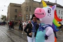 Ein Karnevalist drückt ein Einhorn.