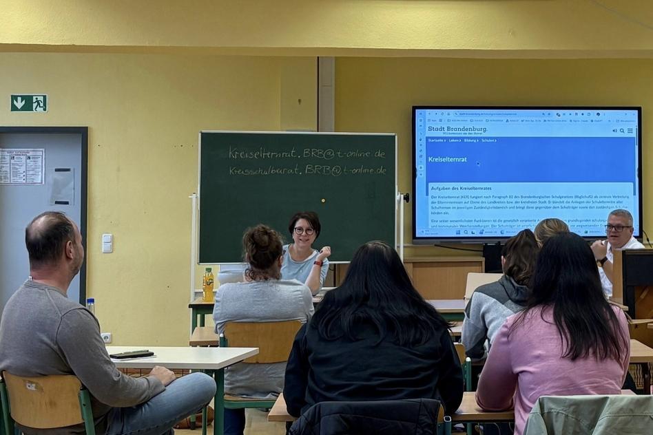 Sitzung von Eltern in einem Schulraum.