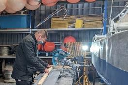 Mitarbeiter beim Arbeiten in der Bootshalle