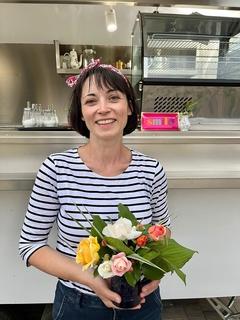 Die Gründerin Jeannette Förster hält einen Blumenstrauß