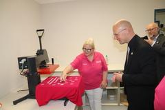 Auf einem Shirt wird ein Label angebracht.