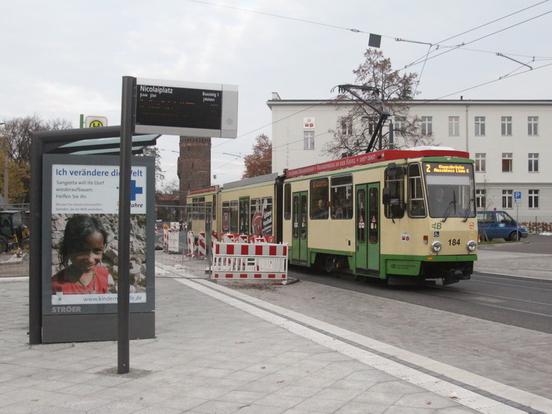Eine Straßenbahn fährt im neuen Gleisbett an der Haltestelle "Nicolaiplatz" vorbei.