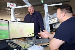 Thomas Barz spricht mit einem Leitstellen-Mitarbeiter.